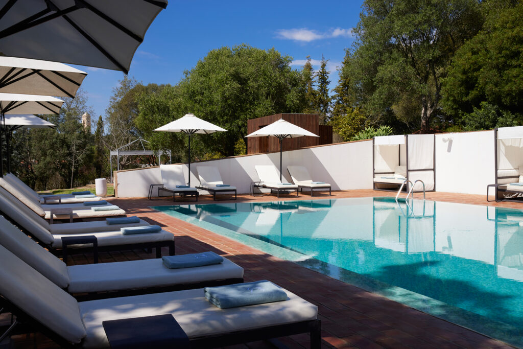 Sun loungers by the outdoor pool at Octant Santiago Hotel