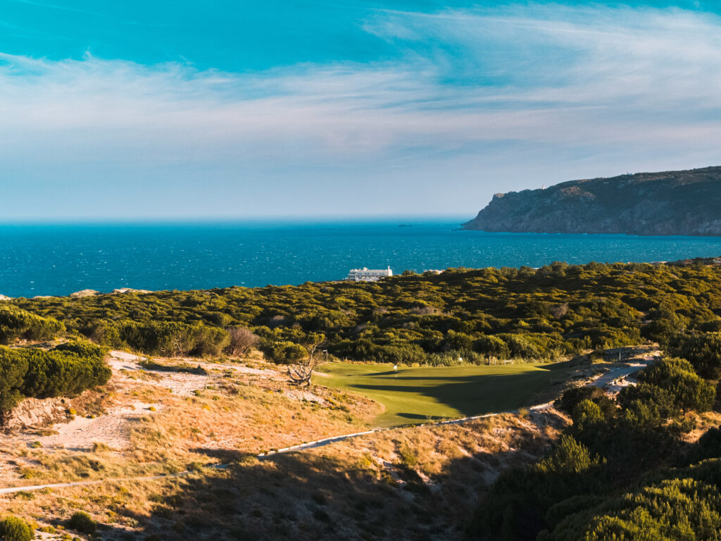 Aerial view of Oitavos Dunes Golf Course with ocean in background