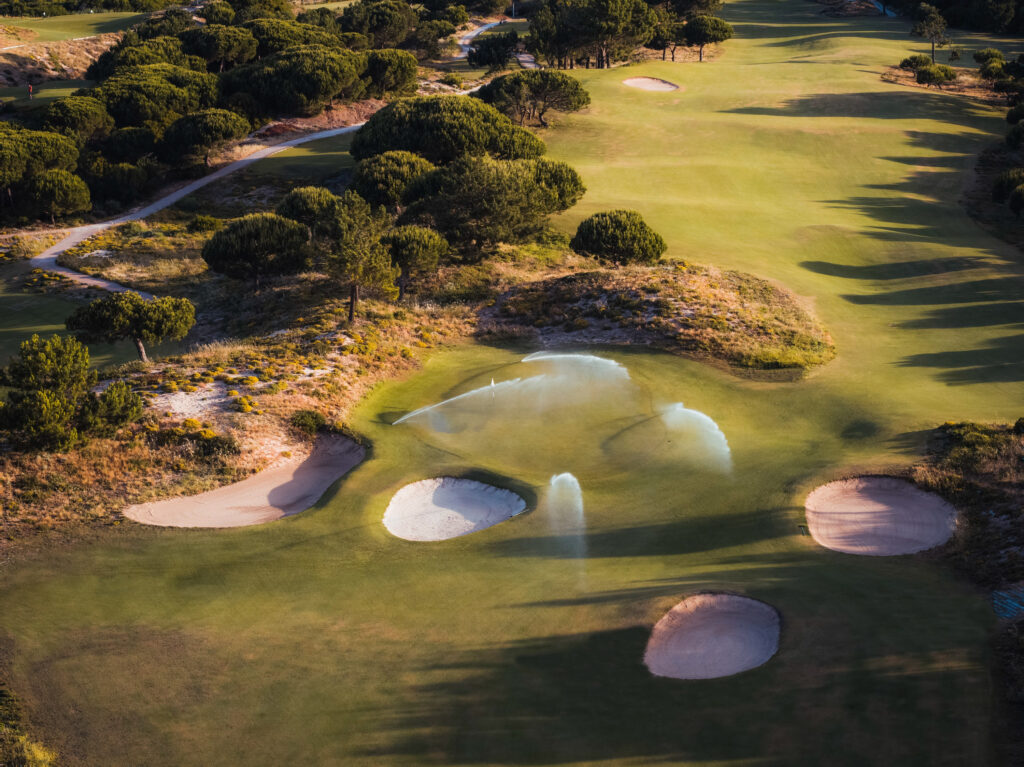 Aerial view of fairway with bunkers and sprinklers on at Oitavos Dunes Golf Course