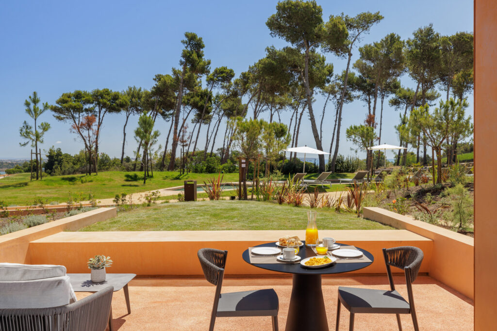 Outdoor patio with views of trees at Palmares Signature Apartments
