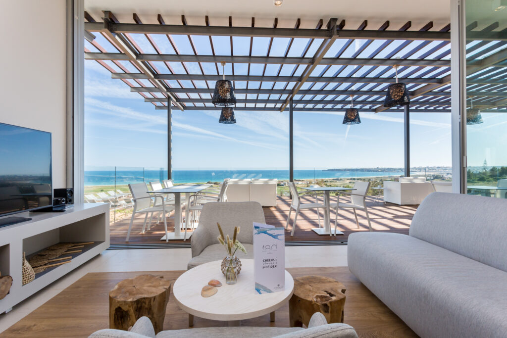 Indoor and outdoor seating area at Palmares Beach House Hotel