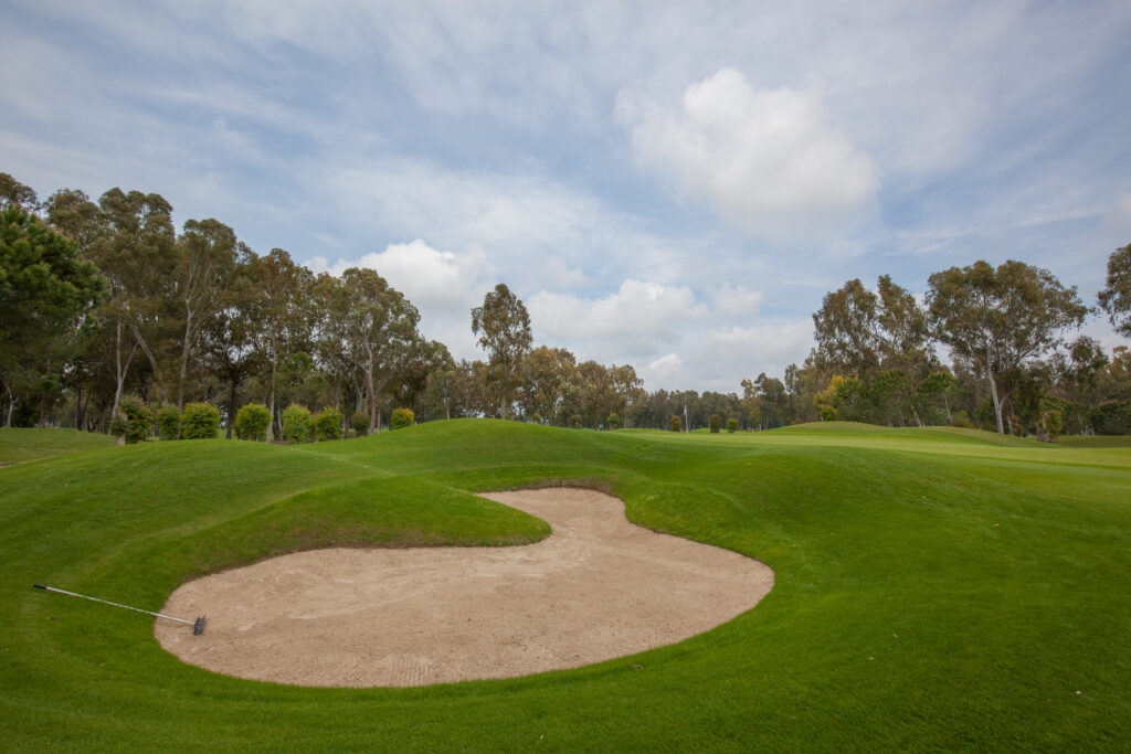 Bunker on fairway with trees around at The Pasha Golf Course