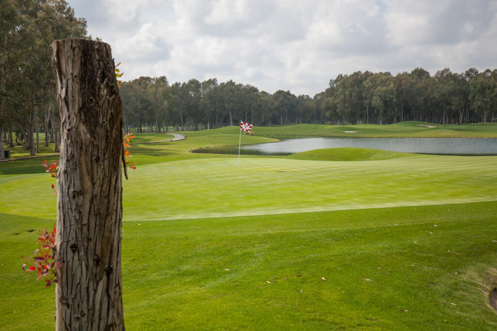 Hole with lake in background and trees around at The Pasha Golf Course