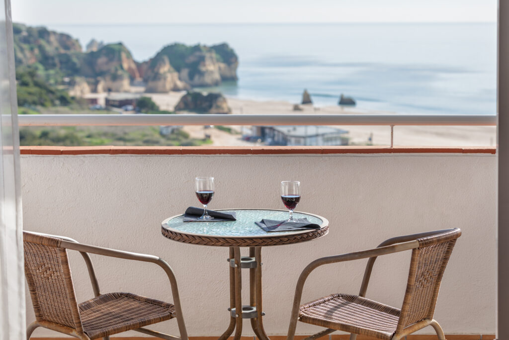 Table and chair on balcony with a beach view at Pastana Alvor Atlantico