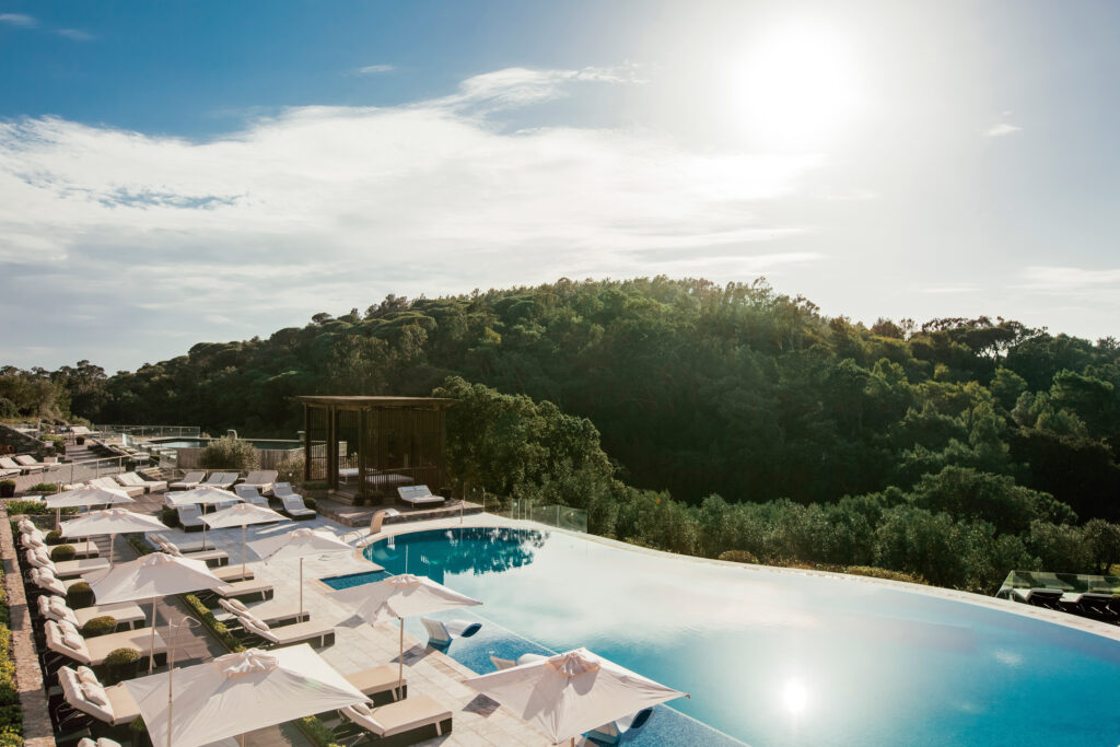 Outdoor pool with sun loungers at Penha Longa Resort