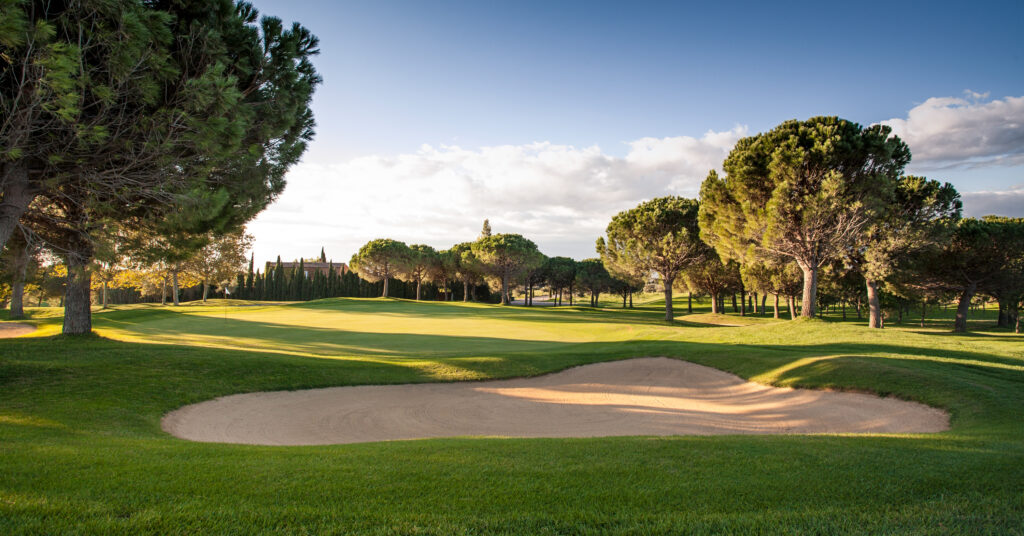 Bunker with hole and white flag at Peralada Golf Course