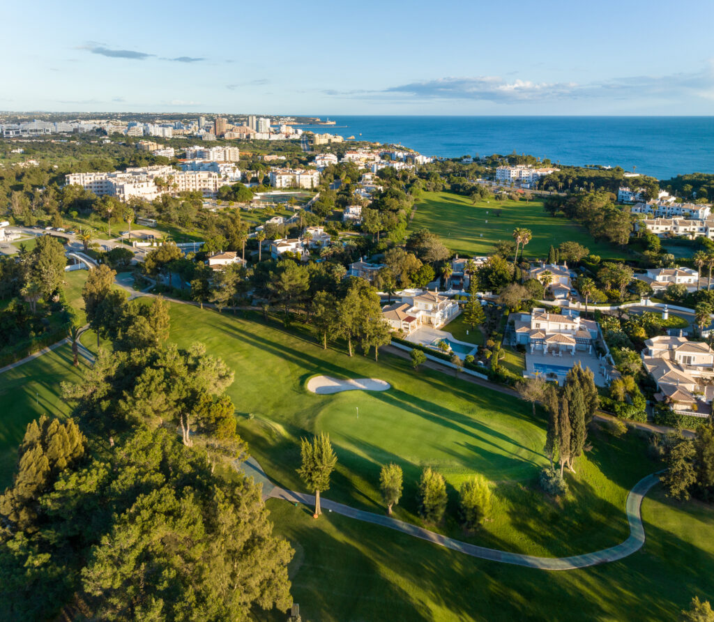 Aerial view of Alto Golf Course with buildings and ocean in background at Alto Golf Course