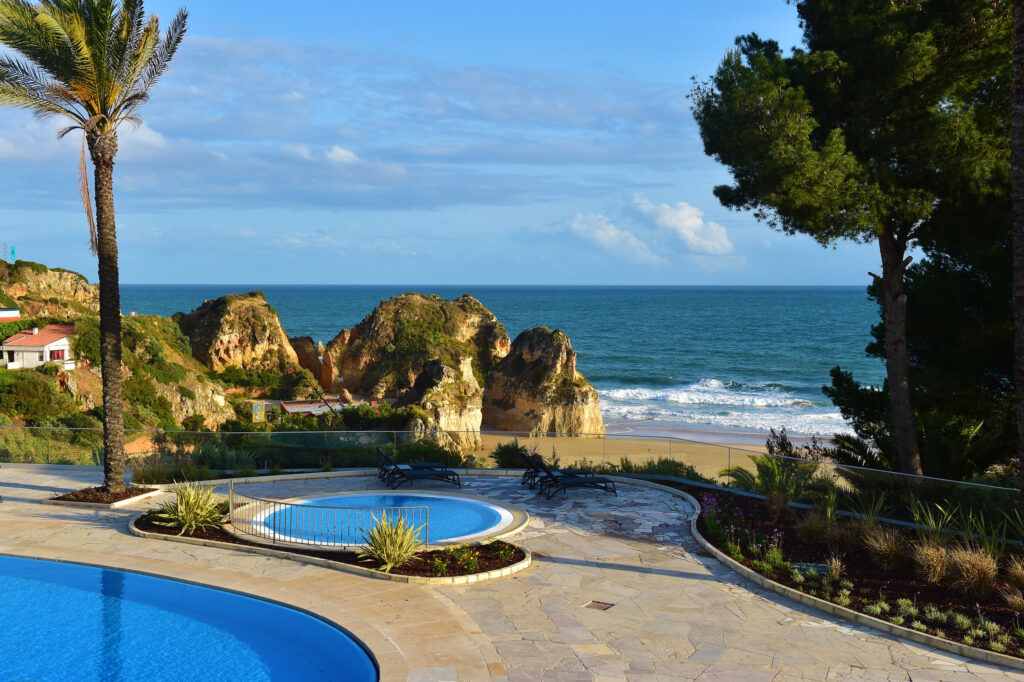 Outdoor pool with beach view at Pestana Alvor Praia