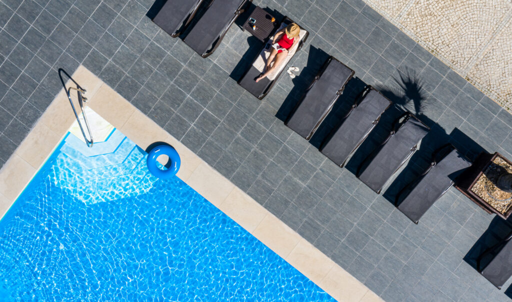 Outdoor pool at Pestana Dom Joao with sun loungers