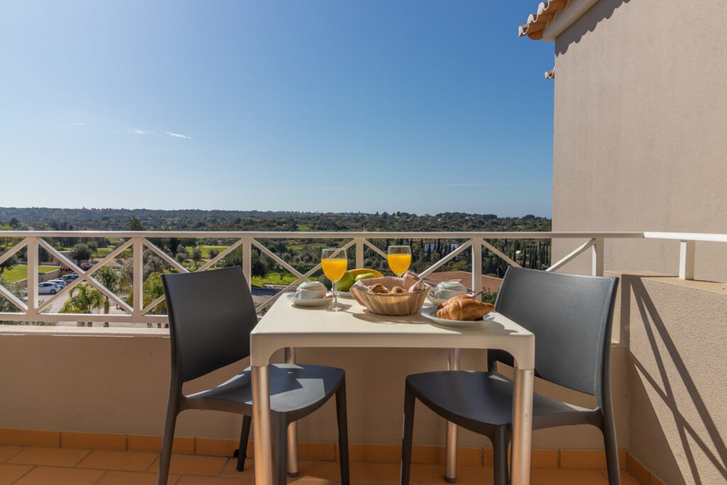 Table and chairs on balcony at Pestana Gramacho Residences Golf Resort