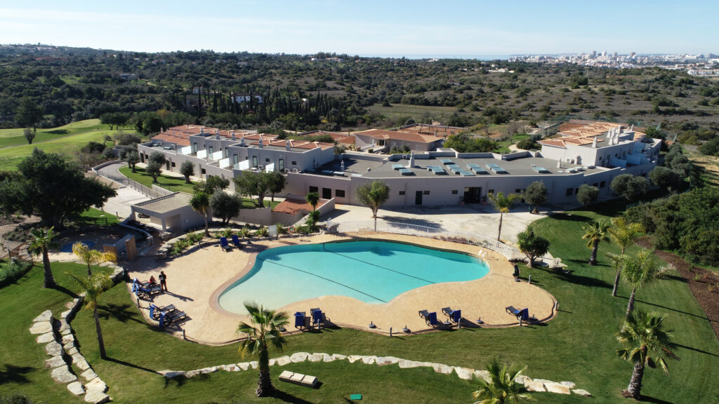 Birdseye view of outdoor pool and residences at Pestana Gramacho Residences Golf Resort