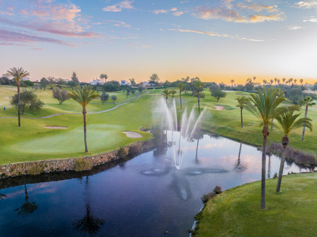 Sprinkler on in water hazard with fairway in background at Gramacho Golf Course