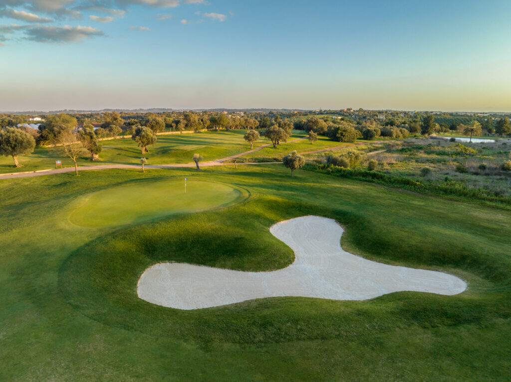 A green at Silves Golf Course with a bunker