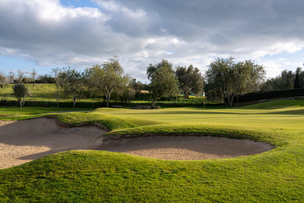 A bunker with trees in background at Pinta Golf Course