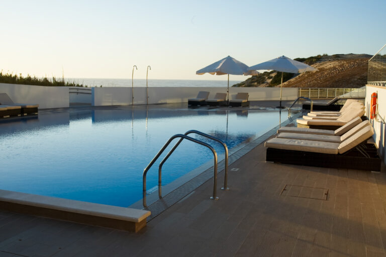Outdoor pool with sun loungers at Praia D'el Rey Golf & Beach Resort