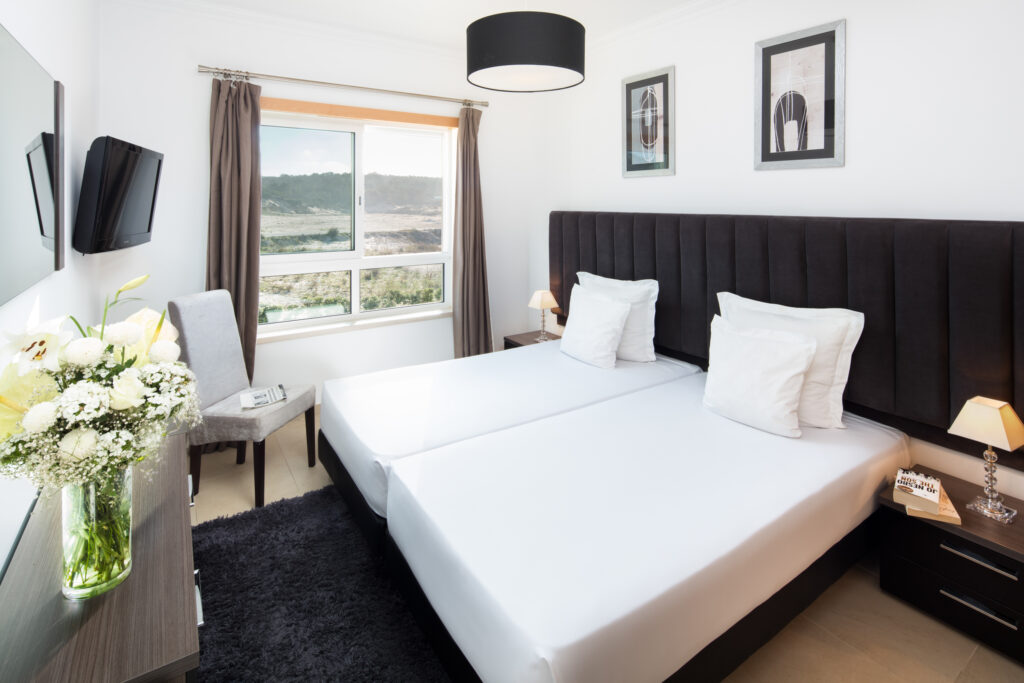 Twin bed accommodation at Praia D'el Rey Golf & Beach Resort