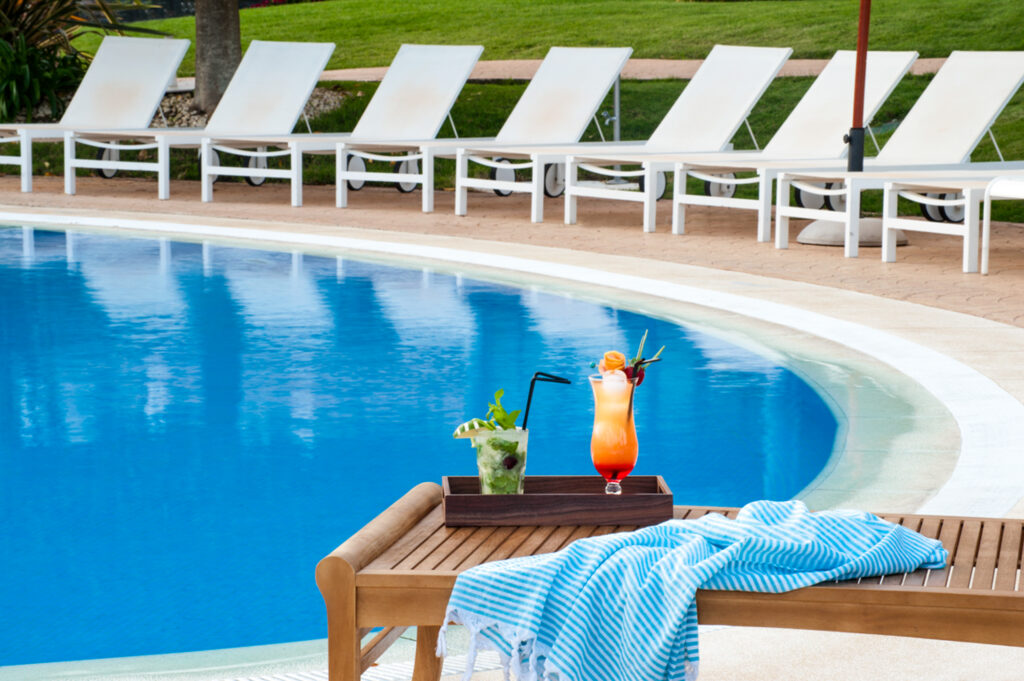 Outdoor pool with sun loungers at Precise Resort El Rompido