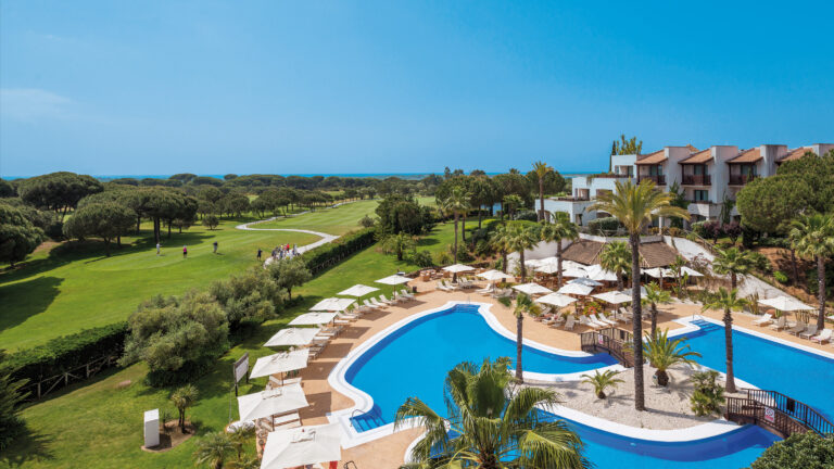 Aerial view of the exterior of Precise Resort El Rompido with outdoor pool and golf