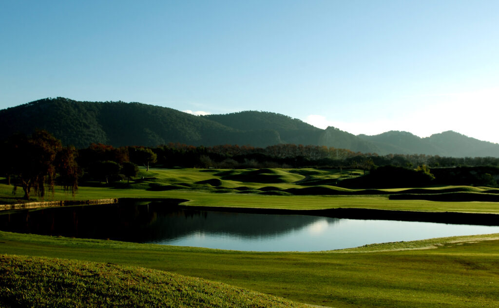 Lake on fairway with trees and hill in background at Pula Golf Club