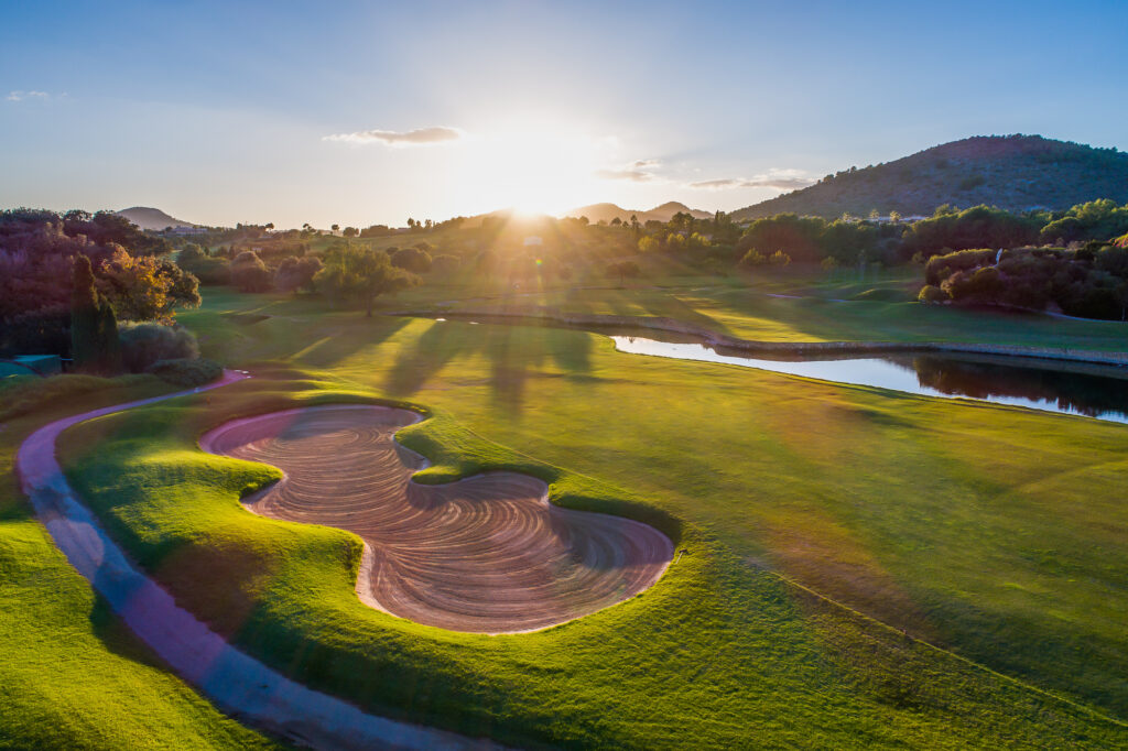 Bunker on fairway with lake and trees at sunset at Pula Golf Club