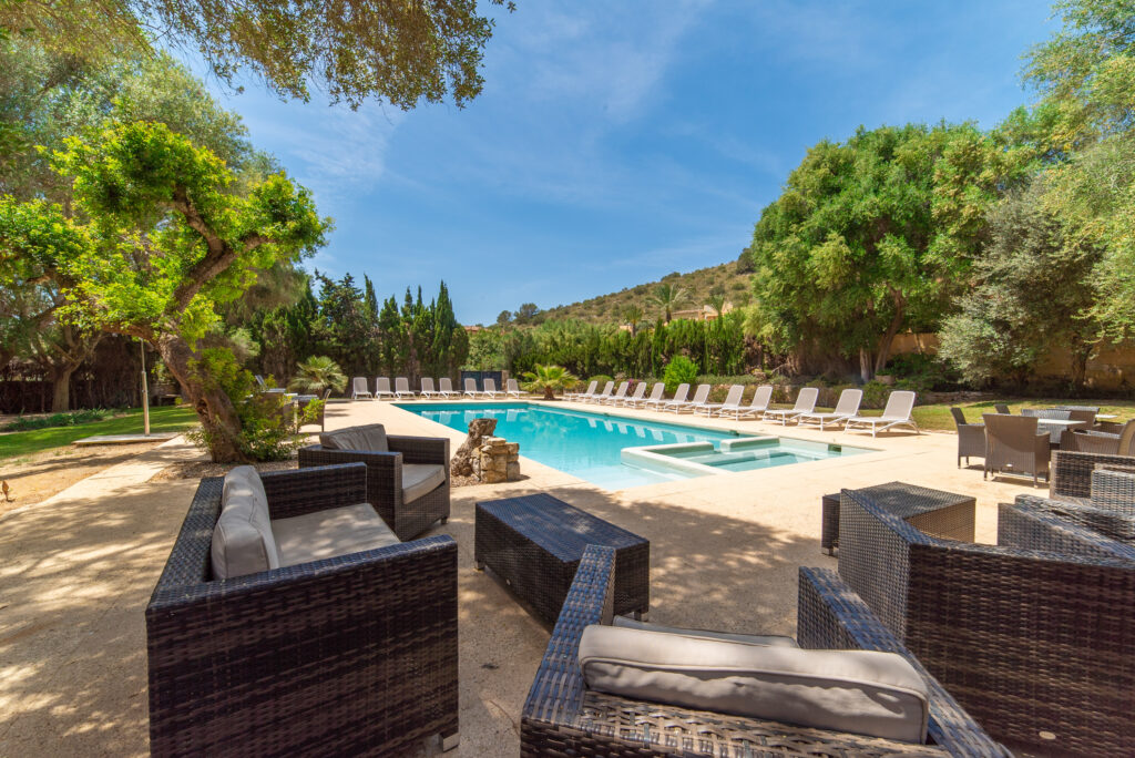 Outdoor pool with seating area at Pula Golf Resort