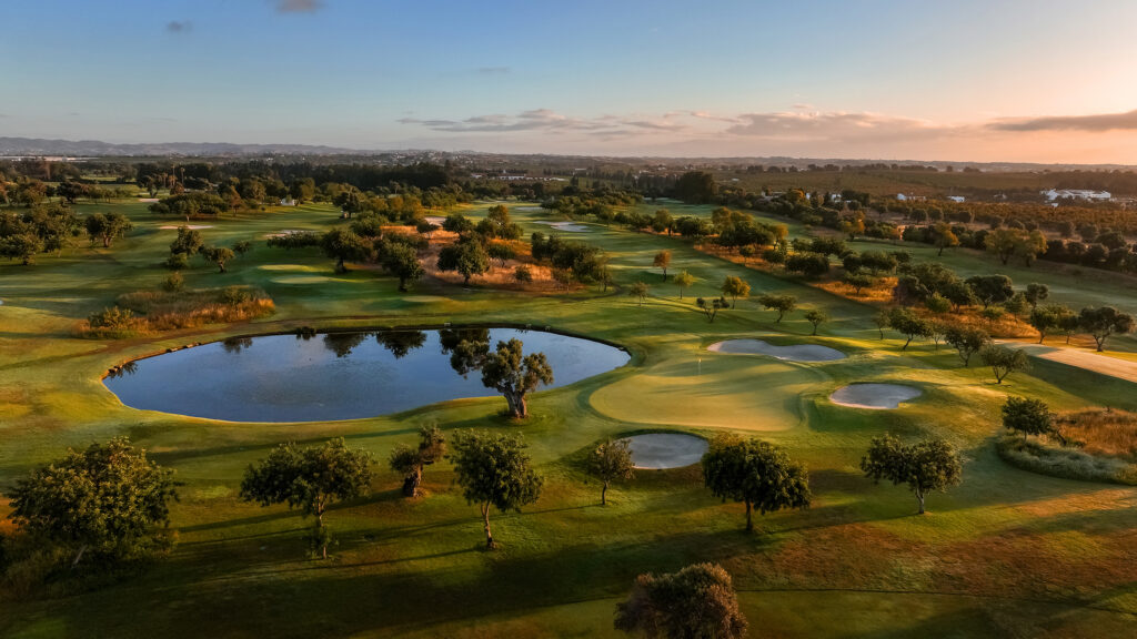 Aerial view of Quinta da Ria Golf Course with a water hazard and bunkers around the green