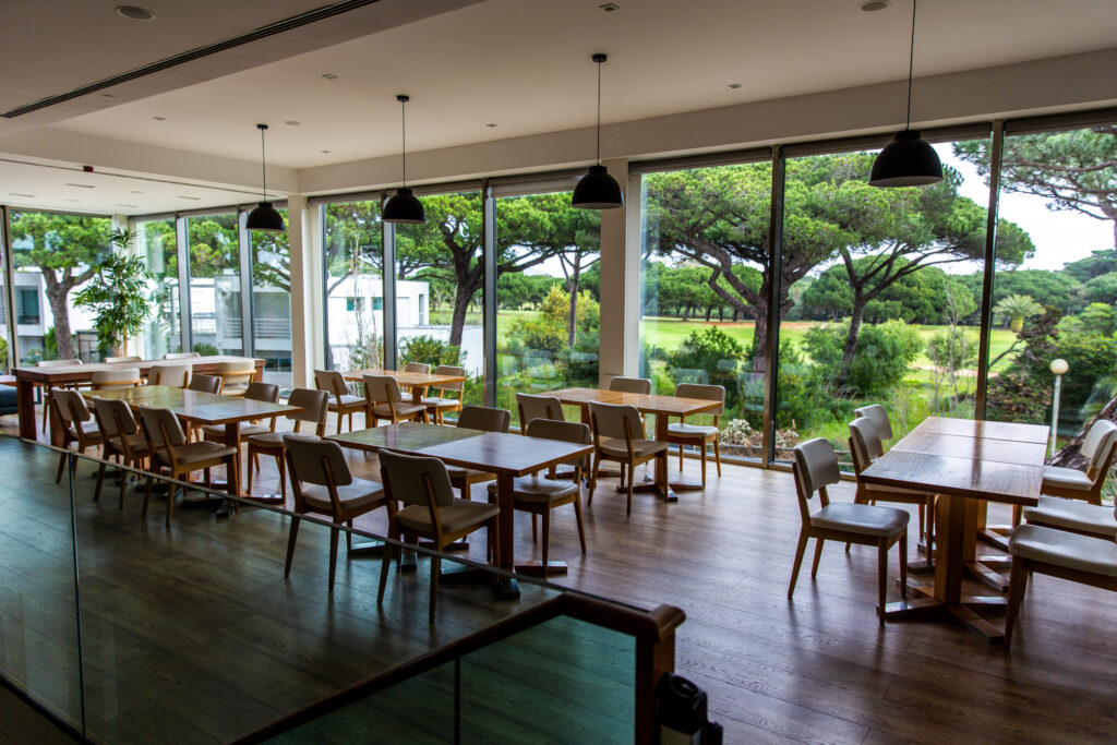 Indoor seating and tables at Onyria Quinta da Marinha Golf Course