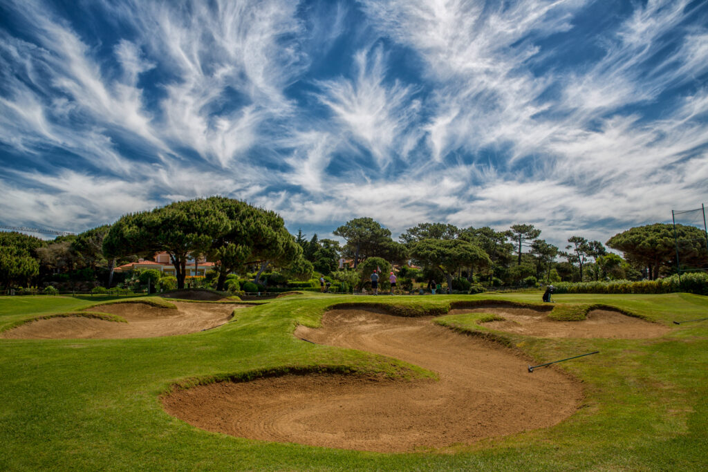 Bunkers with trees in background at Onyria Quinta da Marinha Golf Course