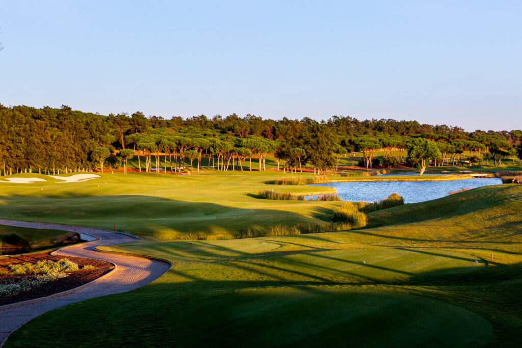 The fairway with a lake and trees in background at Quinta Do Lago Laranjal Golf Course