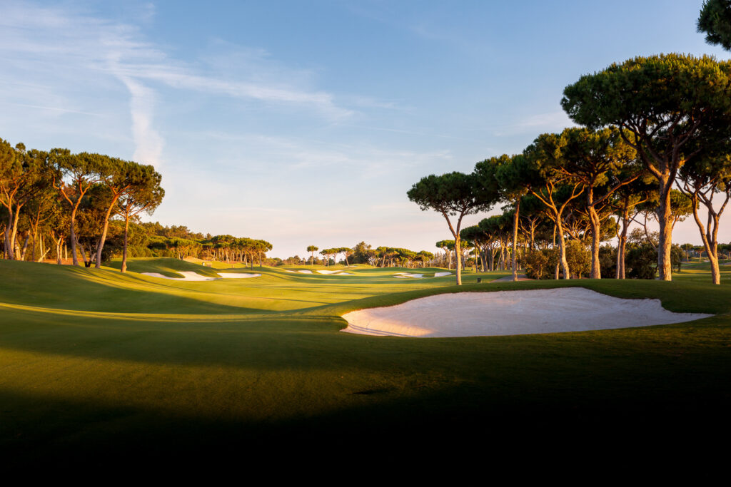 Fairway with bunkers and trees at Quinta Do Lago Laranjal Golf Course