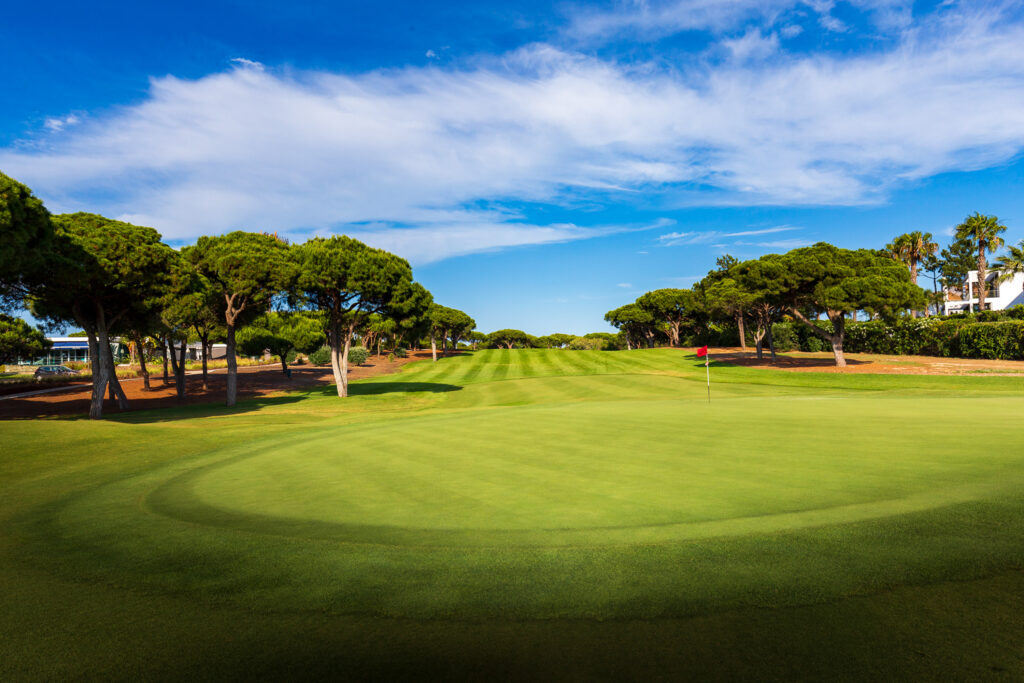 A green with trees around it at Quinta Do Lago North Golf Course