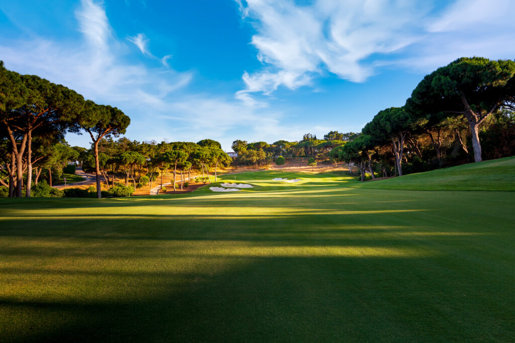 The fairway with bunkers at the end and trees around at Quinta Do Lago North Golf Course