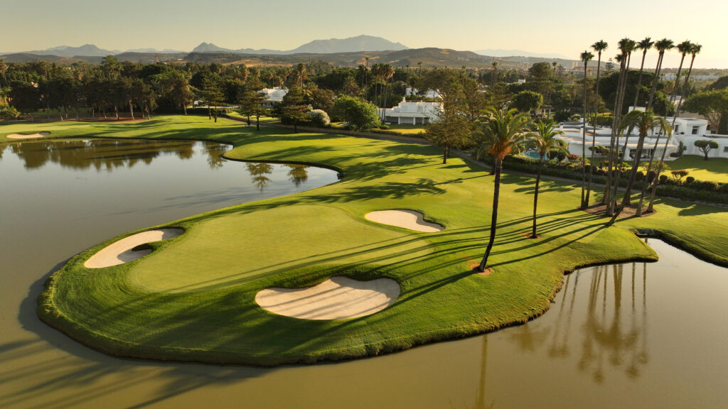 Hole with bunkers and lake around at Real Club Valderrama Golf Course