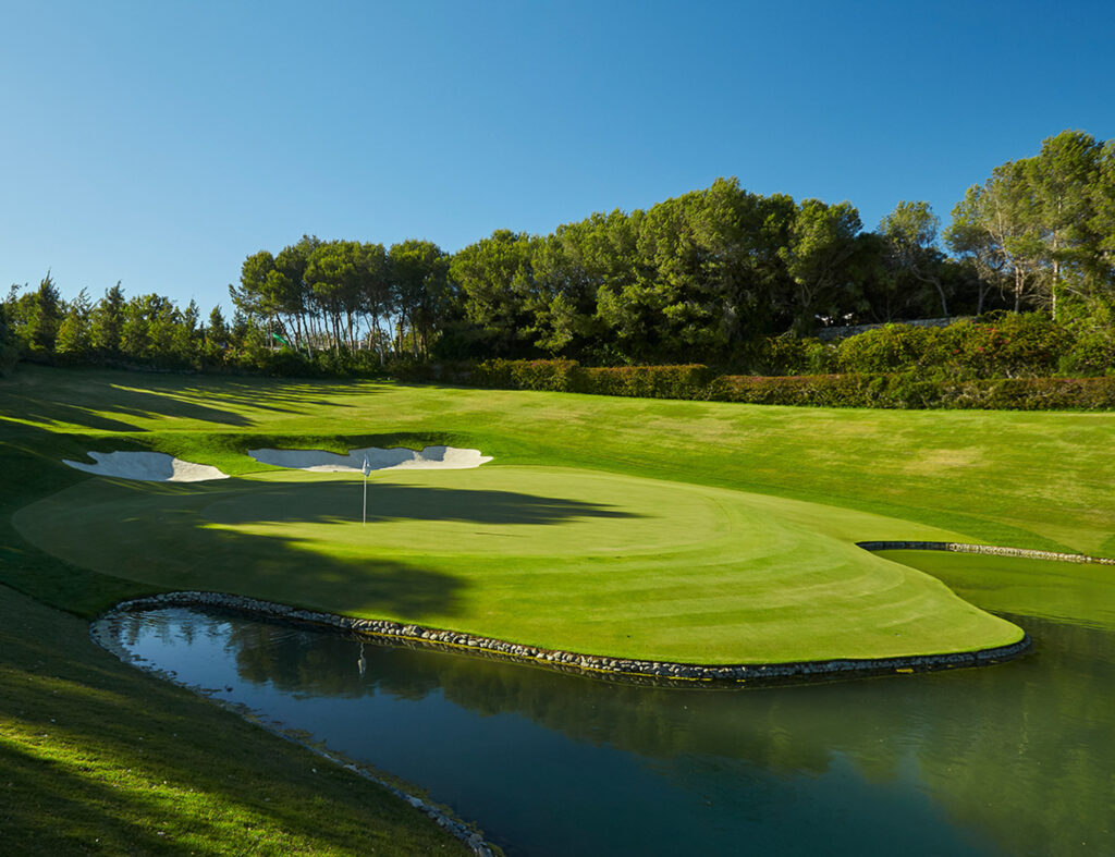 Hole with bunkers and water hazard with trees around at Real Club Valderrama Golf Course