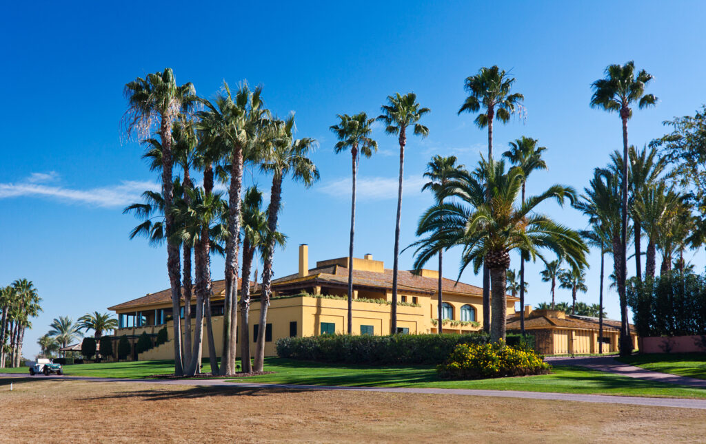 Building with palm trees in front at Real Club Sevilla Golf