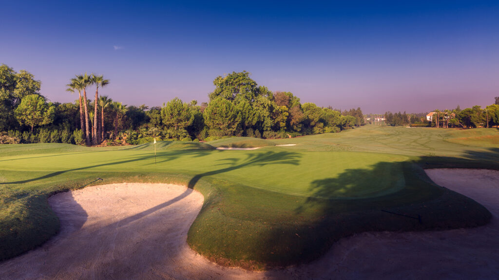 Hole with bunker and trees around at Real Club Sevilla Golf