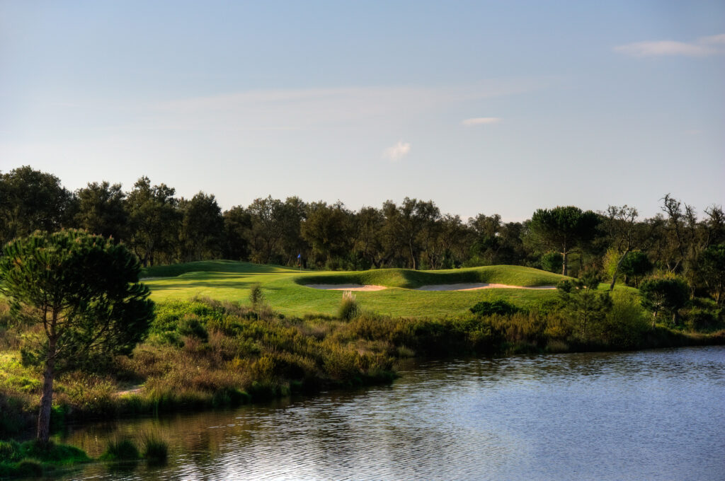 Lake with bunkers and trees in background at Ribagolfe Lakes Golf Course