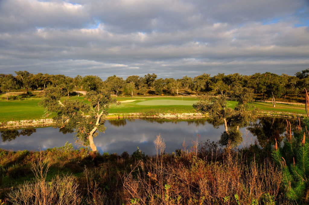 Water hazard with hole and fairway in background at Ribagolfe Oaks Golf Course