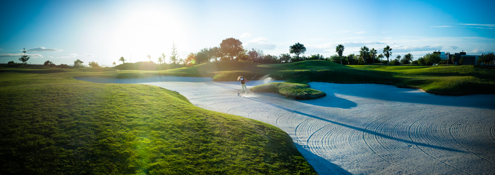 Bunker on fairway with person playing golf at Roda Golf Course