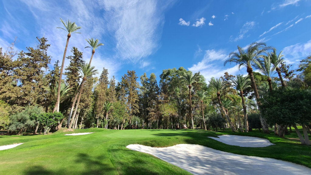 Hole with bunkers and trees around at Royal Golf Marrakech