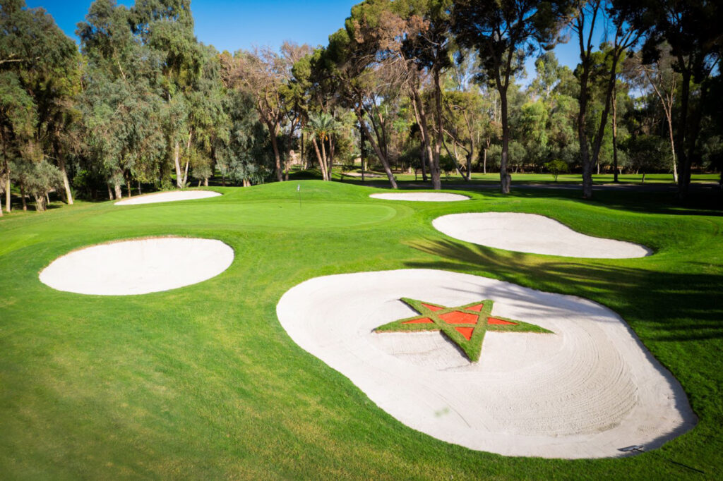 Bunker with star in it at Royal Golf Marrakech with trees around