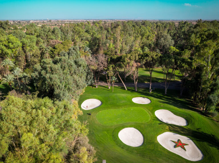 Aerial view of hole with bunkers around at Royal Golf Marrakech with trees around