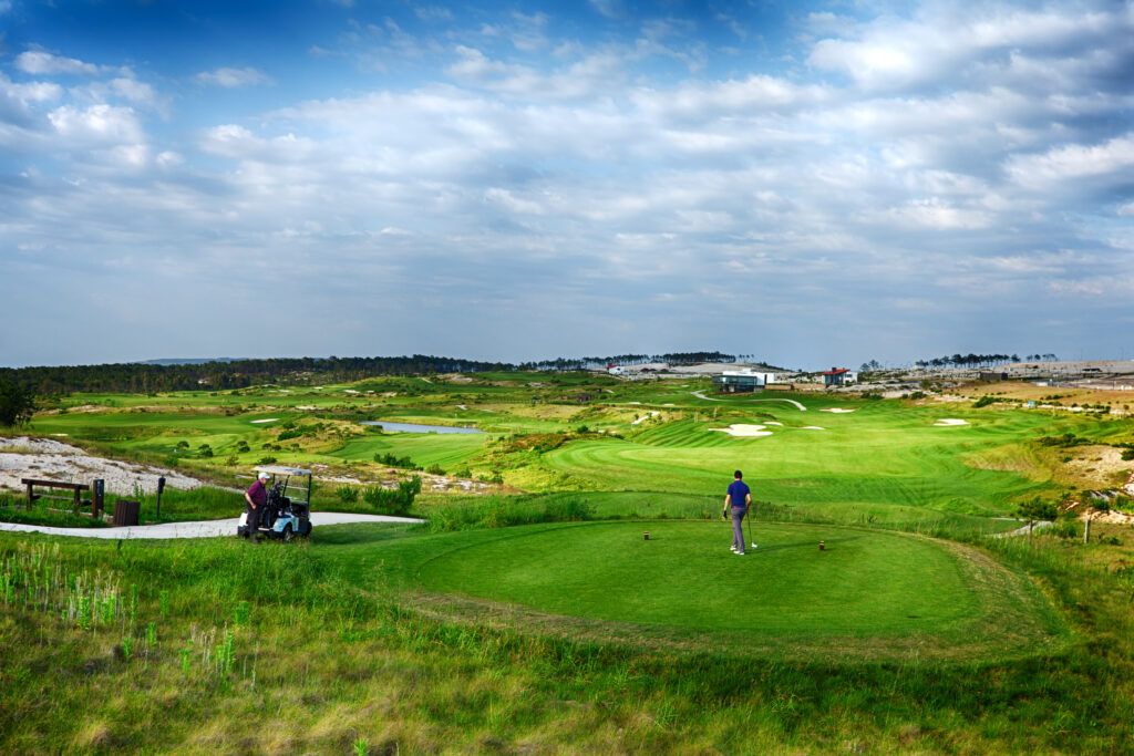 People playing golf with a buggy at Royal Obidos Golf Course