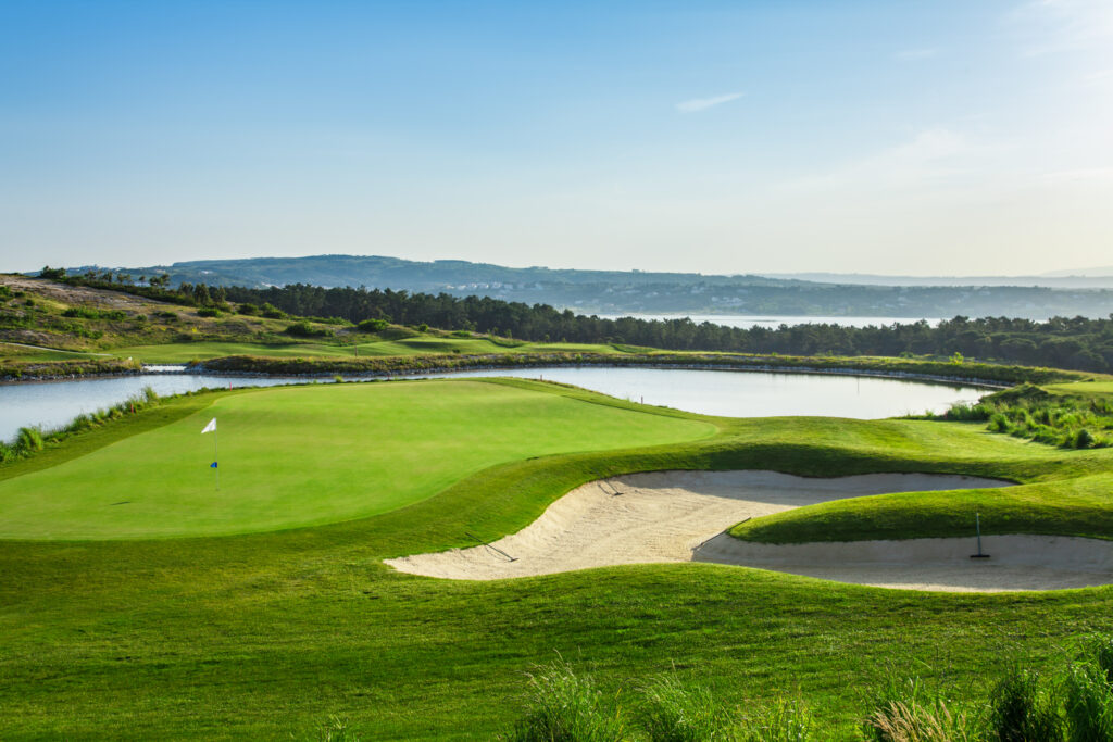 A hole at Royal Obidos Golf Course with water hazard and bunkers around