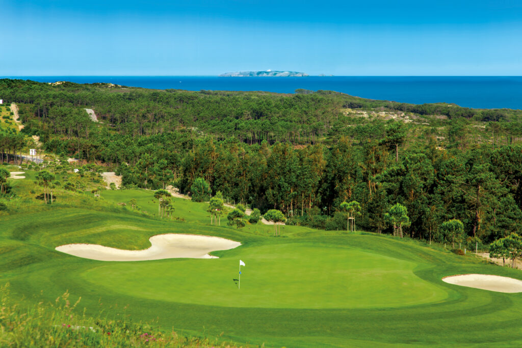 Aerial view of a hole at Royal Obidos Golf Course with trees in background