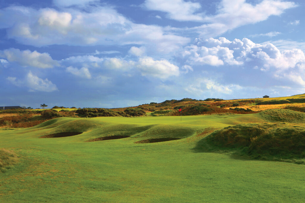 Hole with red flag and bunkers at Royal Porthcawl