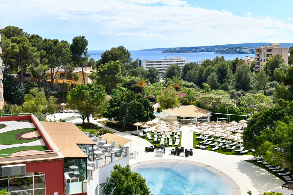 Outdoor pool with outdoor seating at Salles Hotel Marina Portals