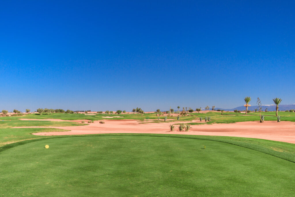 Tee box at Samanah Golf & Country Club overlooking fairway with bunkers and trees around