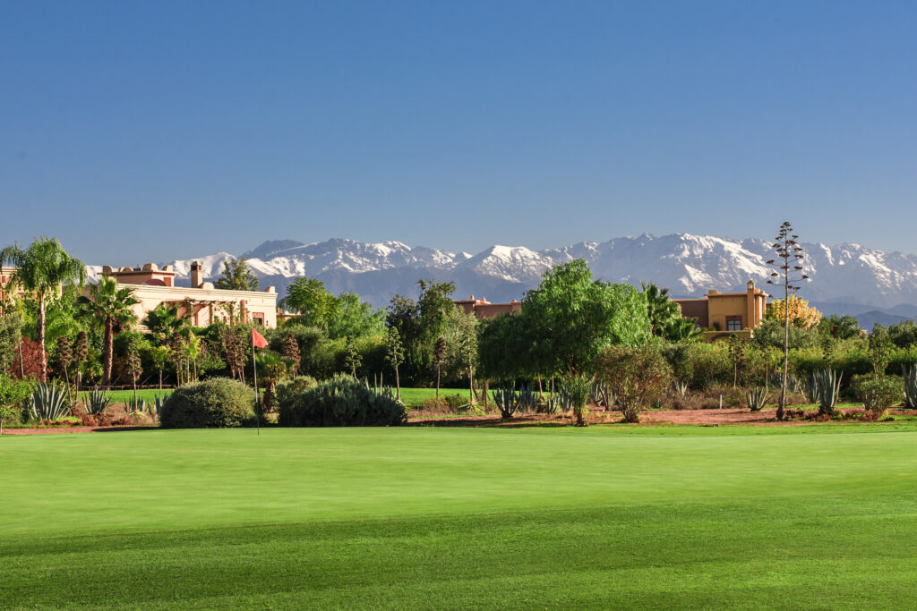 Fairway at Samanah Golf & Country Club with buildings, trees and mountains in distance