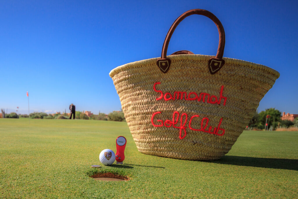 Samanah Golf & Country Club bag next to a ball and pitch mark repair tool